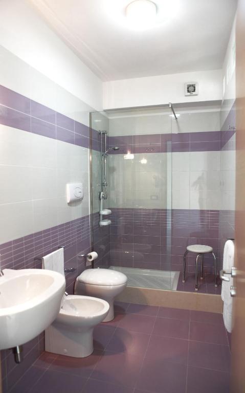 a bathroom with two toilets and a sink and a shower at Brezza Di Grecale in Trapani