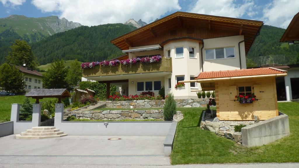 ein Haus mit einem Berg im Hintergrund in der Unterkunft Ferienwohnung Lejo in Virgen