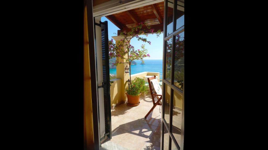 A balcony or terrace at Natalia Apartment A with panoramic sea views of Agios Gordios bay
