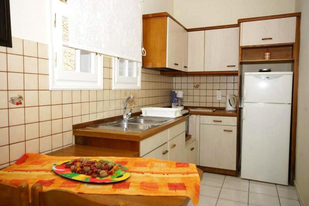 A kitchen or kitchenette at Natalia Apartment A with panoramic sea views of Agios Gordios bay