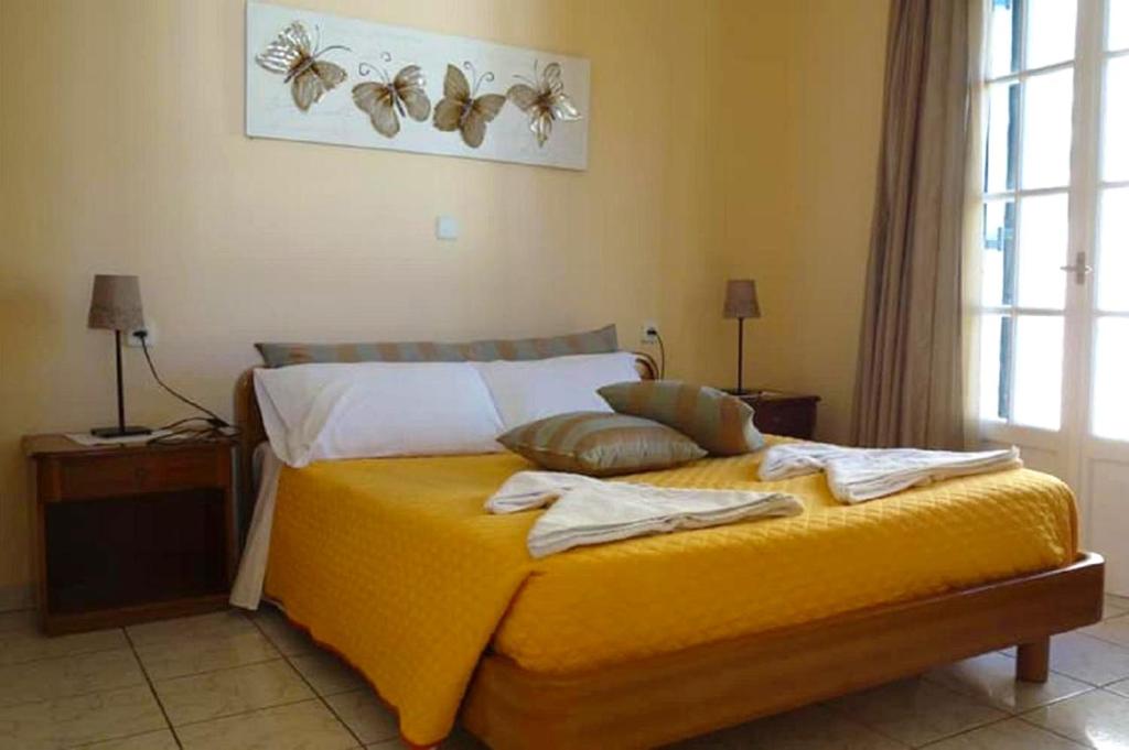 A bed or beds in a room at Natalia Apartment A with panoramic sea views of Agios Gordios bay