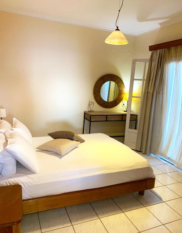 A bed or beds in a room at Natalia Apartment A with panoramic sea views of Agios Gordios bay