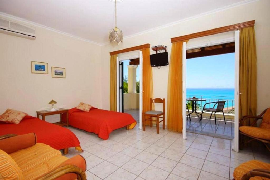 A seating area at Natalia Apartment A with panoramic sea views of Agios Gordios bay