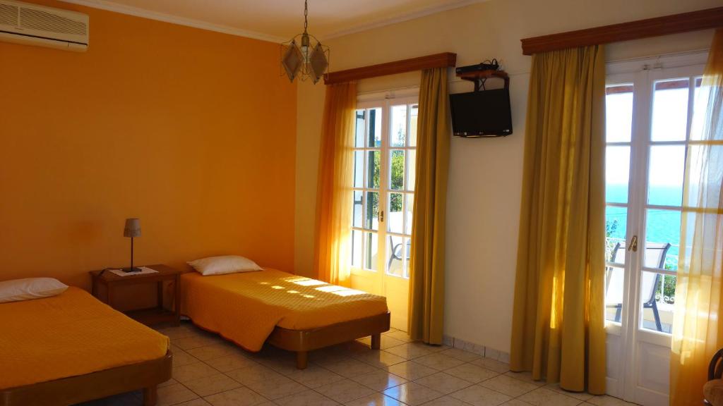 A bed or beds in a room at Natalia Apartment A with panoramic sea views of Agios Gordios bay