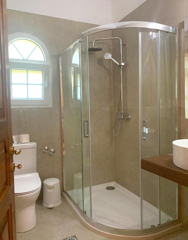 A bathroom at Natalia Apartment A with panoramic sea views of Agios Gordios bay