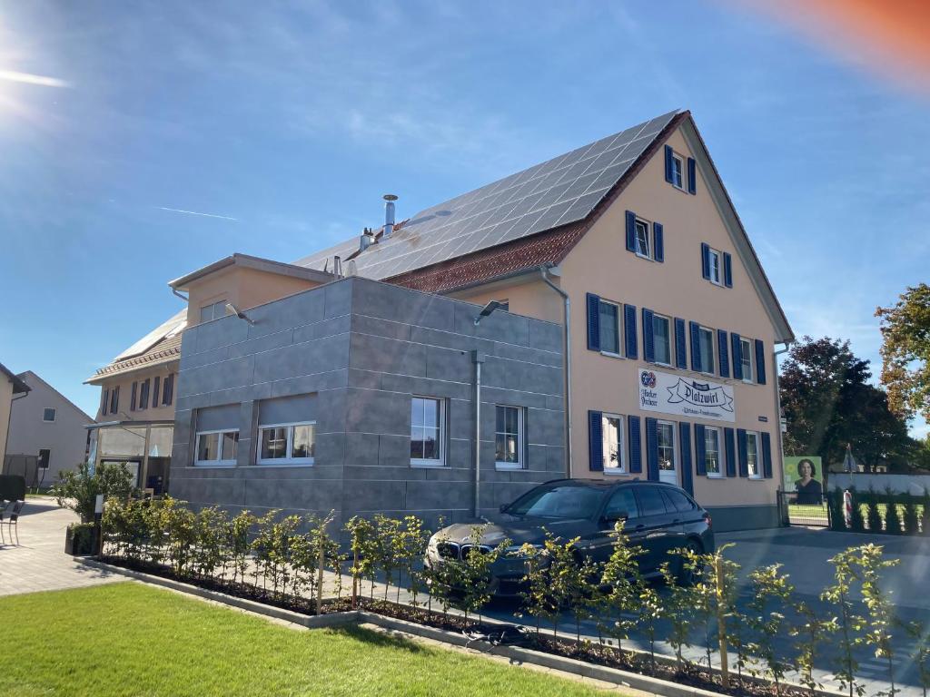 a house with a car parked in front of it at Platzwirt in Unterschneidheim