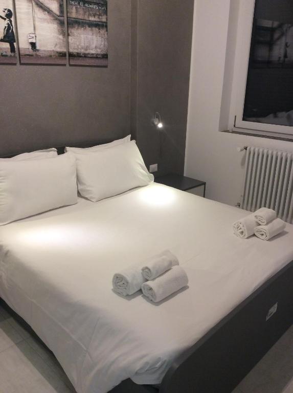 a bed with two towels and two pillows on it at Dolce Riposo in Cinisello Balsamo