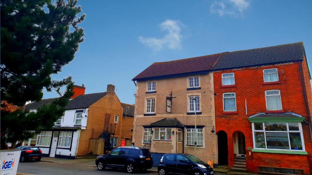 a group of brick houses on a street at The Coach House in Kegworth