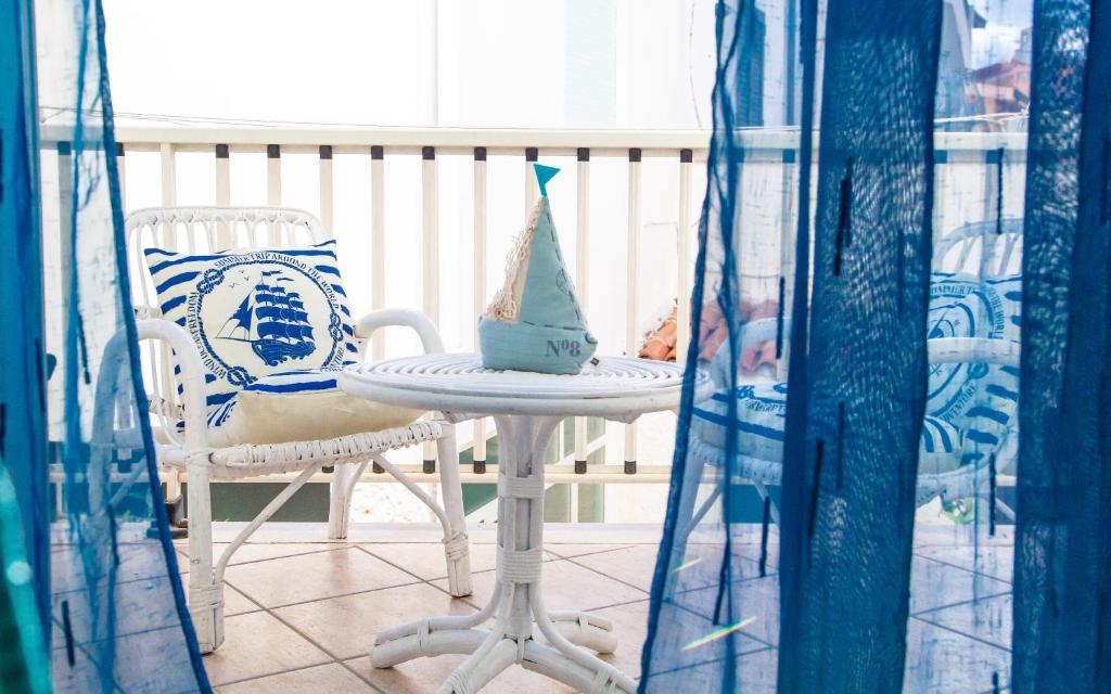 a table and two chairs with a party hat on it at Lungomare Bay, e sei in spiaggia... in Cala Gonone
