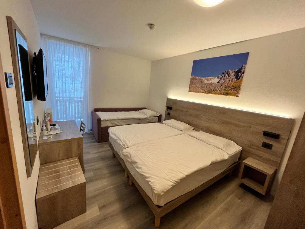 Postel nebo postele na pokoji v ubytování Hotel Zanella