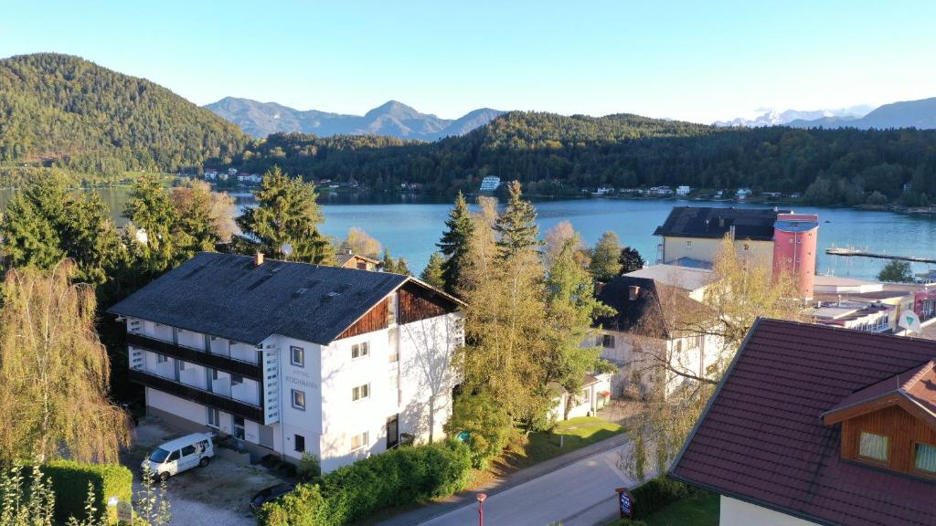 an aerial view of a town with a lake and mountains at Hotel Reichmann in Sankt Kanzian