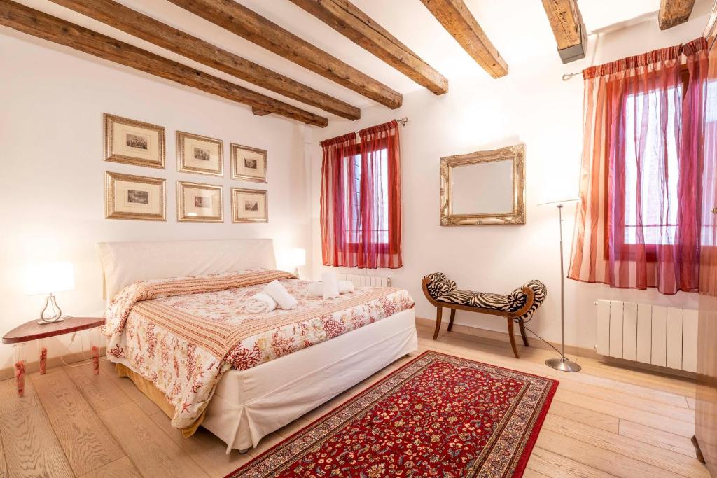 a bedroom with a bed and a red rug at San Marco New Romantic in Venice