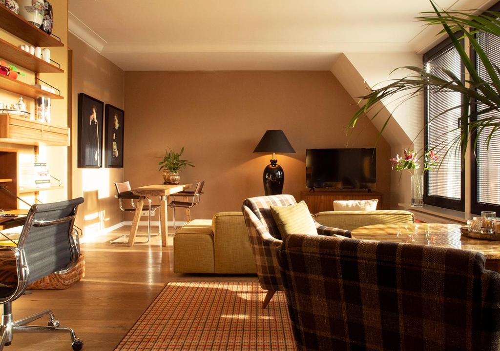 a living room with two couches and a table at Aplace Antwerp boutique flats & hotel rooms in Antwerp