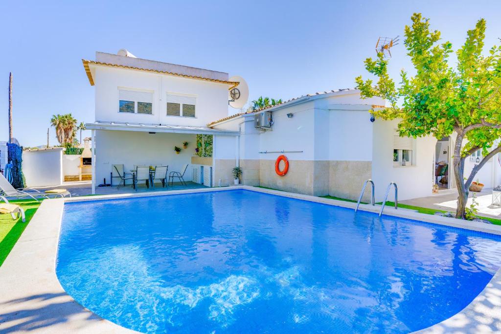 a swimming pool in front of a house at Casa Blanca Alcudia in Alcudia