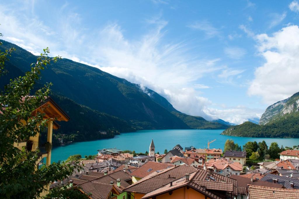 a view of a town with a lake and mountains at Hotel Lory in Molveno