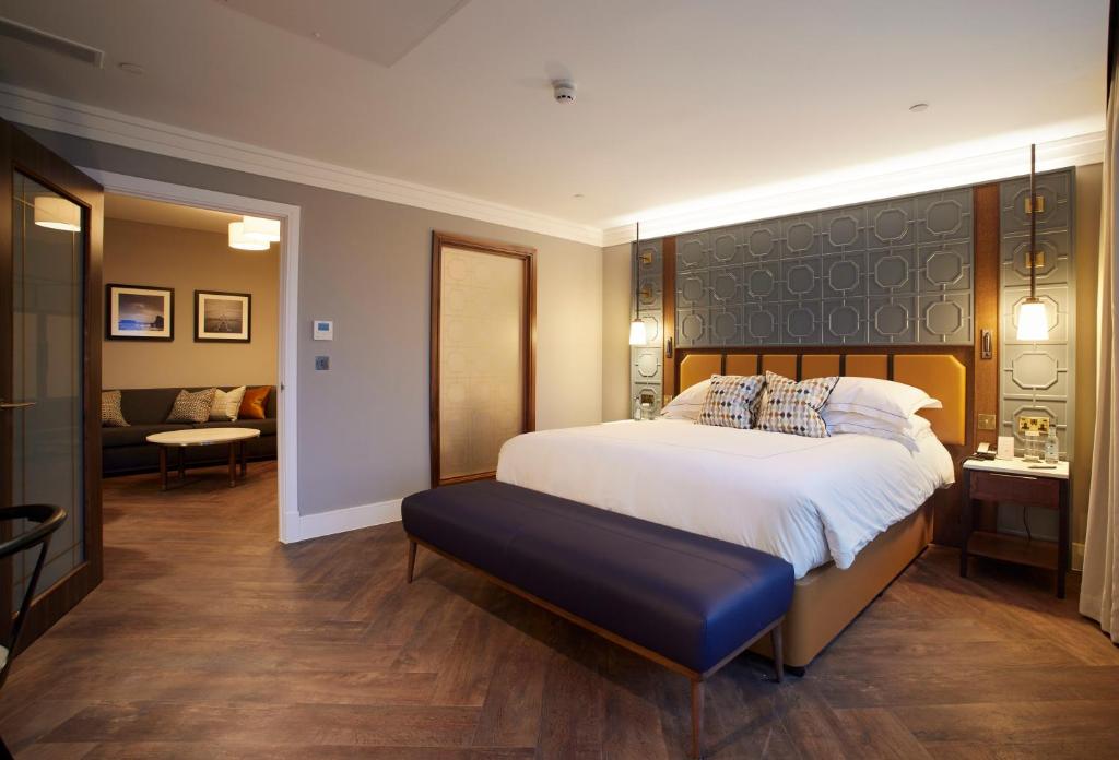 a large bedroom with a large bed and a couch at The Parkgate Hotel in Cardiff