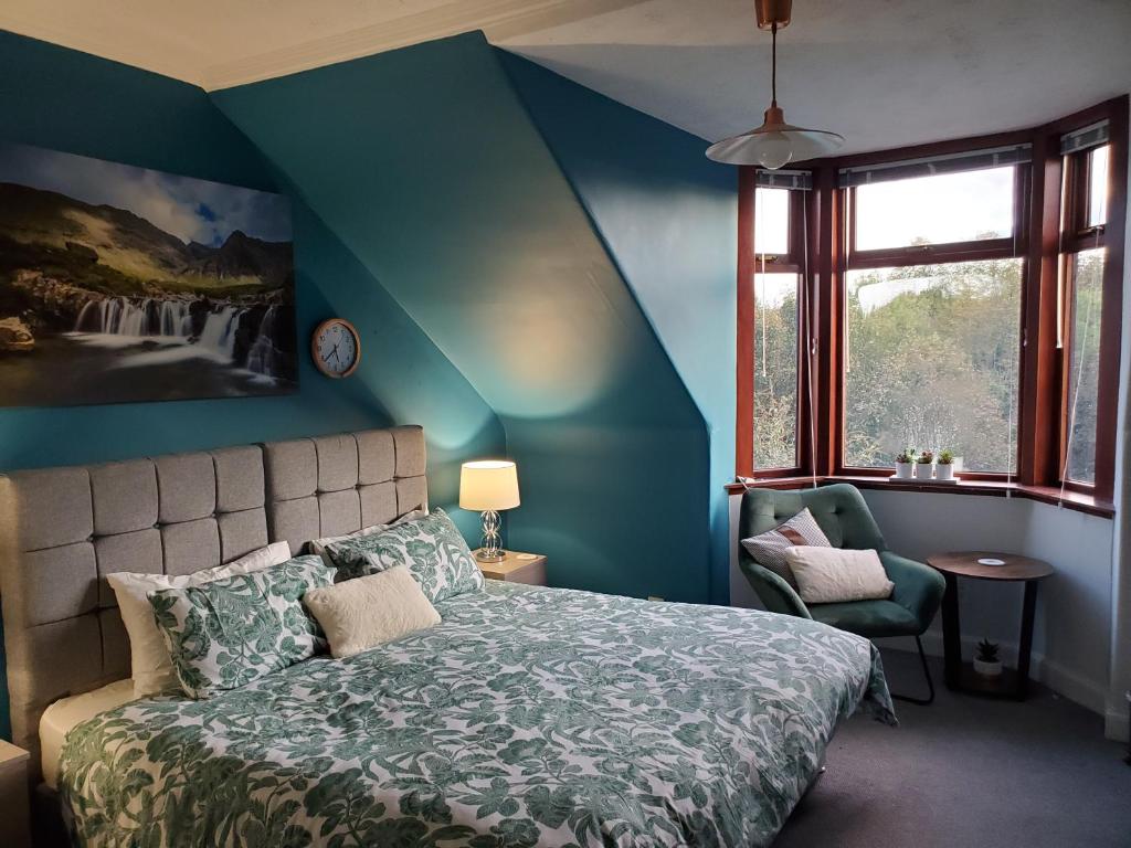 a blue bedroom with a bed and a chair at Carvetii - Mayhaven House - Tranquil Cul-de-Sac - 2 Bedrooms, Sleeps 4 Guests in Dunfermline