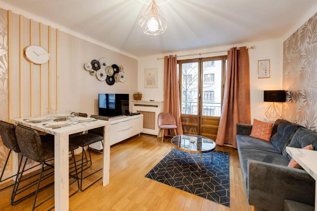 a living room with a table and a couch at Les Mulots - Apartment T3 of 56 sqm in Annecy