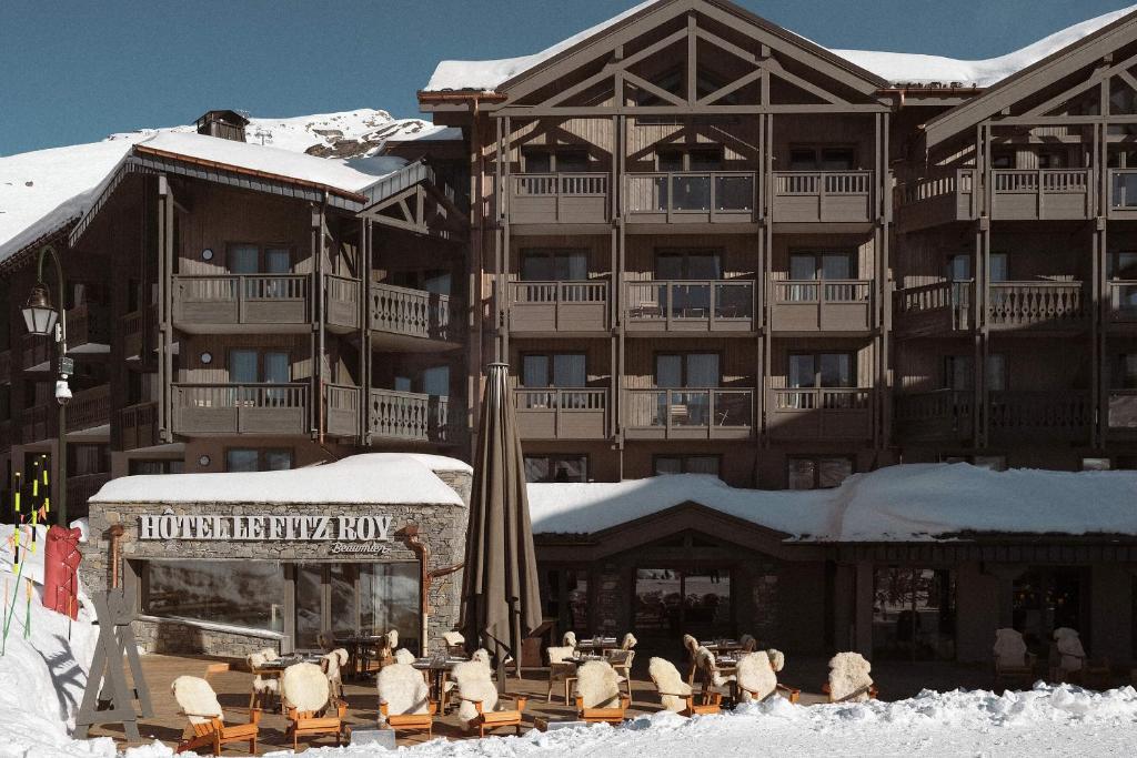a large resort building with snow on the ground at Le Fitz Roy, a Beaumier hotel in Val Thorens
