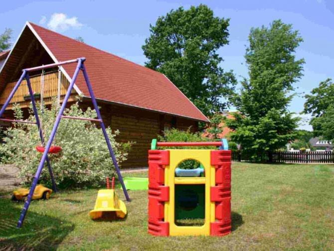 a playground in a yard with a play equipment at Ferienhaus Maria in Mönkebude