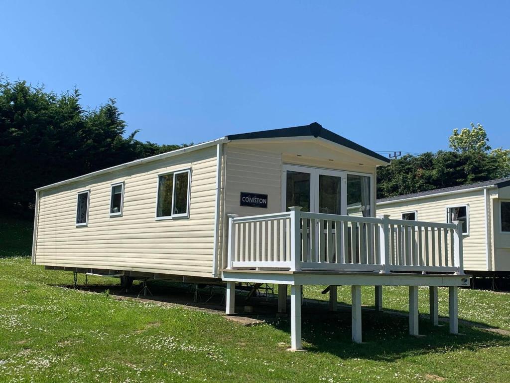 a mobile home with a porch and a deck at Luxury 2 Bedroom Caravan LG13, Shanklin, Isle of Wight in Shanklin