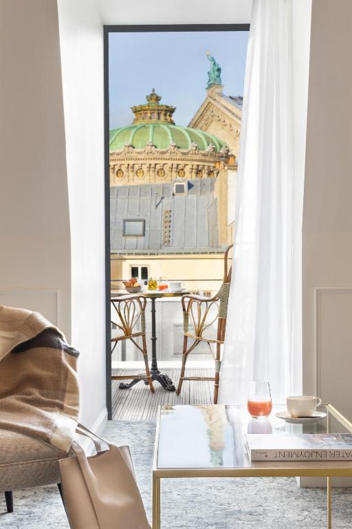 a living room with a view of a building at Maison Albar - Le Vendome in Paris