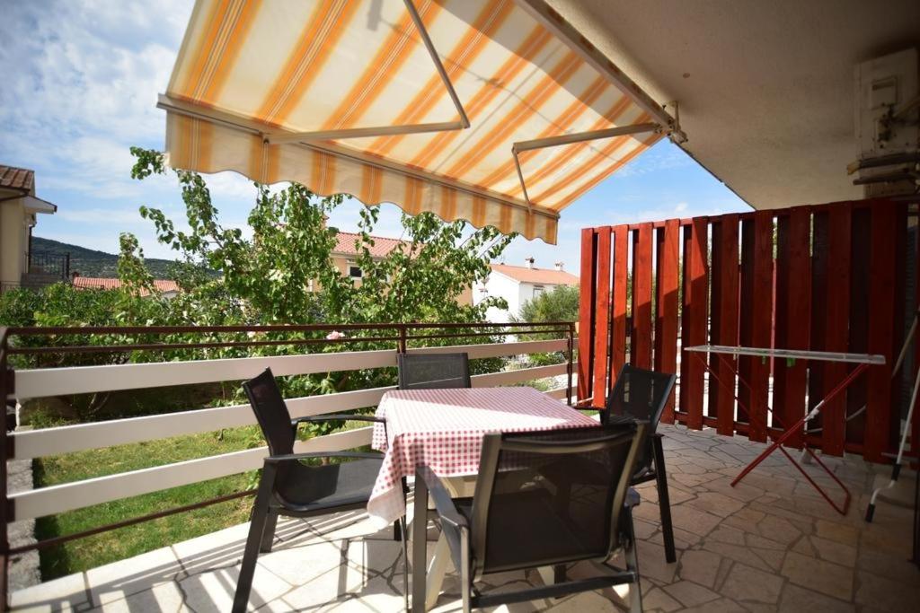 a patio with a table and chairs and an umbrella at Apartment CRES 4249-2 in Cres