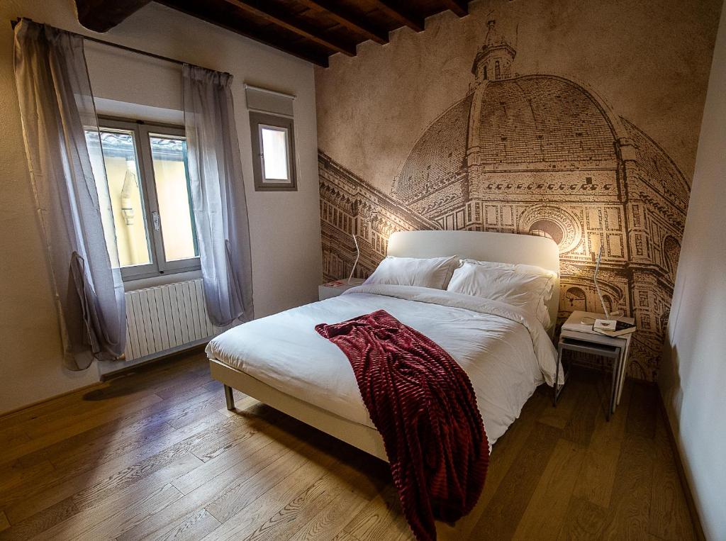 A bed or beds in a room at Acacia Firenze - Girasole