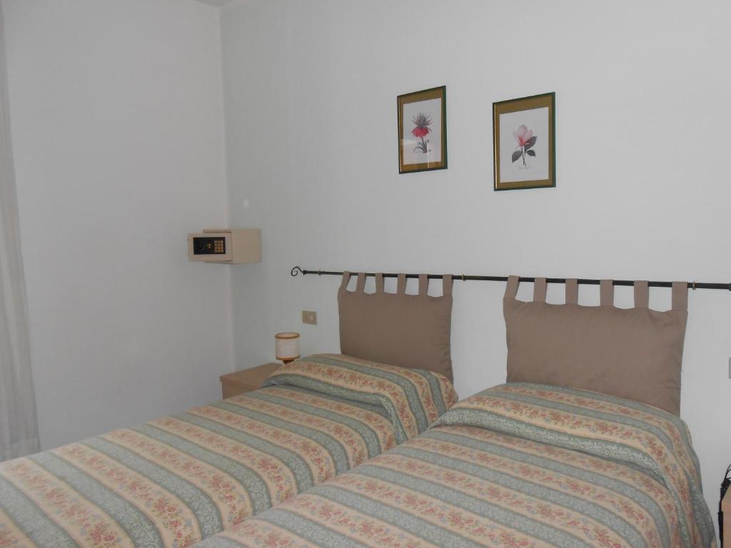 Postel nebo postele na pokoji v ubytování Albergo Genzianella
