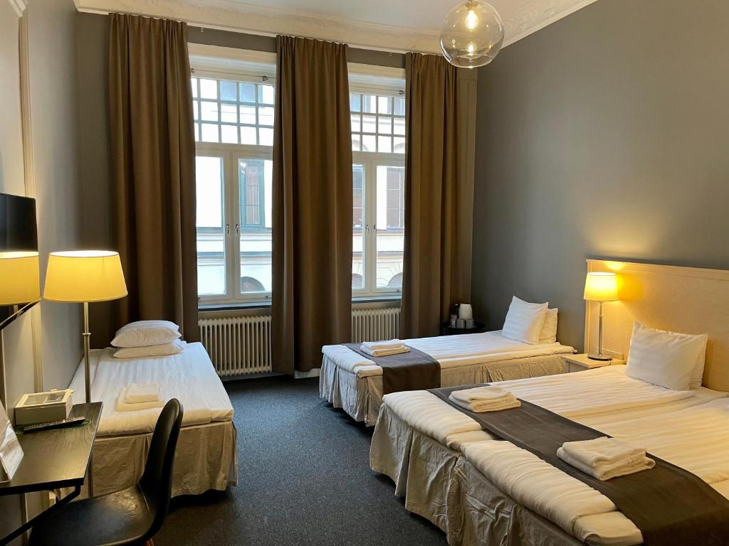 Postel nebo postele na pokoji v ubytování Unique Hotel