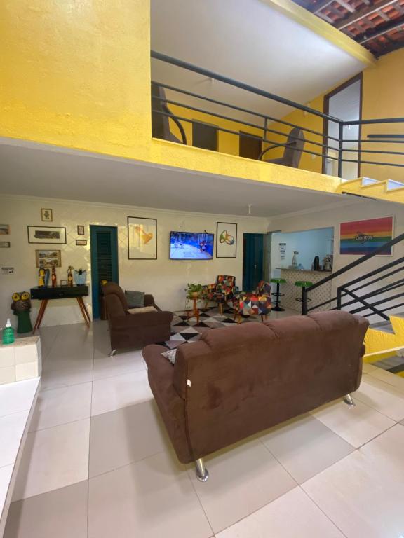 a large living room with a couch and a tv at RioSlz Hostel in São Luís
