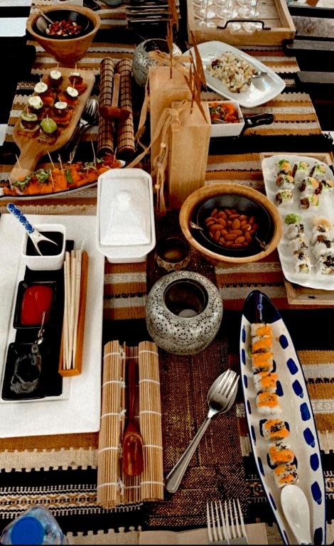 a table with many plates of food on it at Casa BOHO in Alaminos