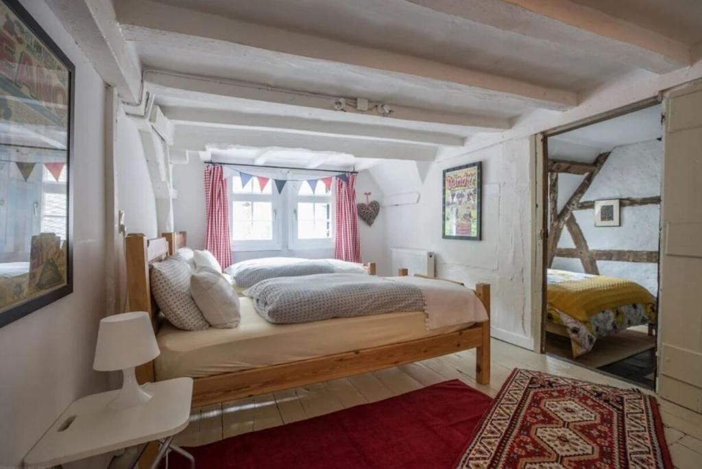 a bedroom with a large bed and a window at Boutique Fachwerkhaus Thirty Five in Monschau