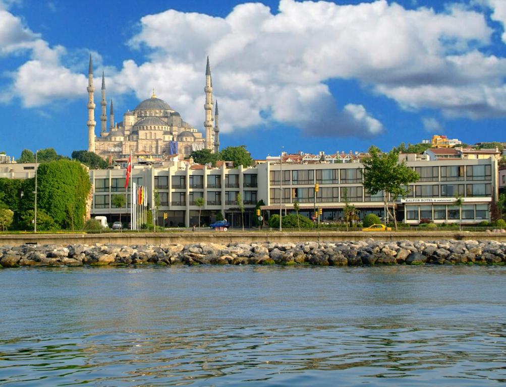 a large body of water with buildings and a lighthouse at Kalyon Hotel Istanbul in Istanbul