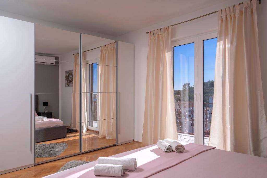 a bedroom with a bed and a large mirror at Villa M&M - ZF Hvar in Hvar