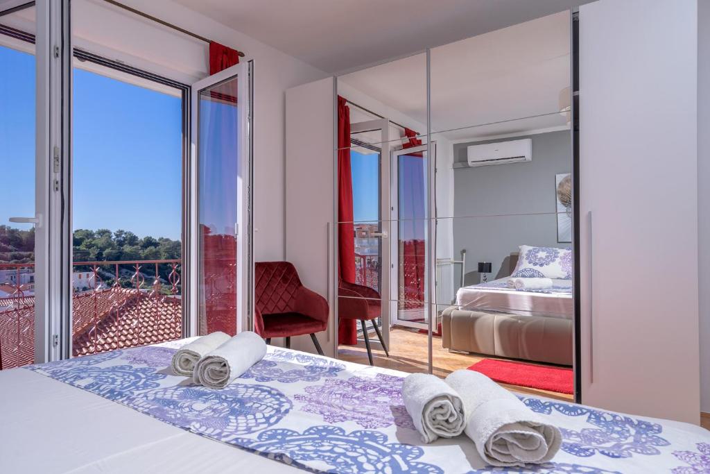 a bedroom with a bed and a balcony at Villa M&M - ZF Hvar in Hvar