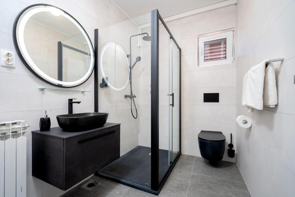 a bathroom with a black sink and a mirror at Villa M&M - ZF Hvar in Hvar