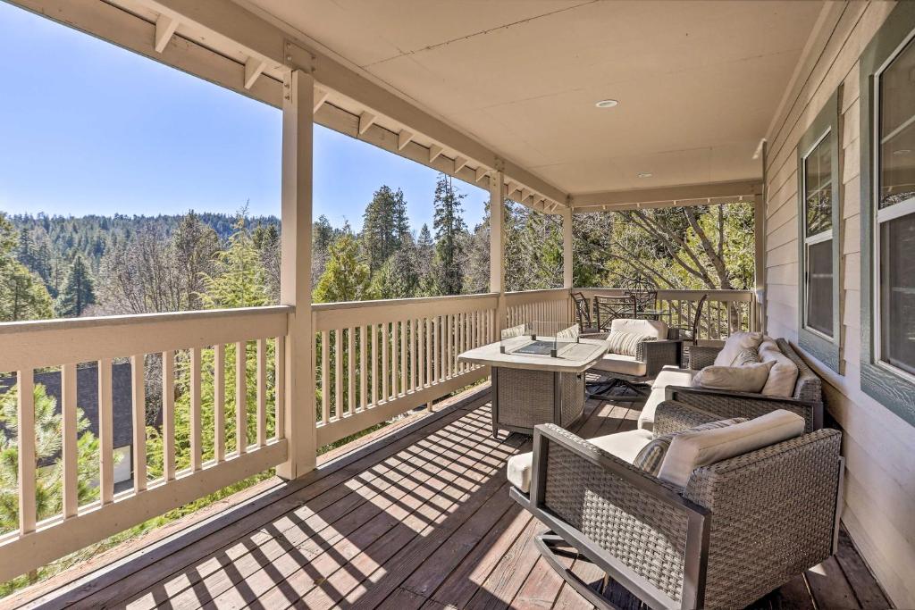 a screened in porch with chairs and a table at Huge Lake Arrowhead Home with 3 Decks and Grill! in Lake Arrowhead