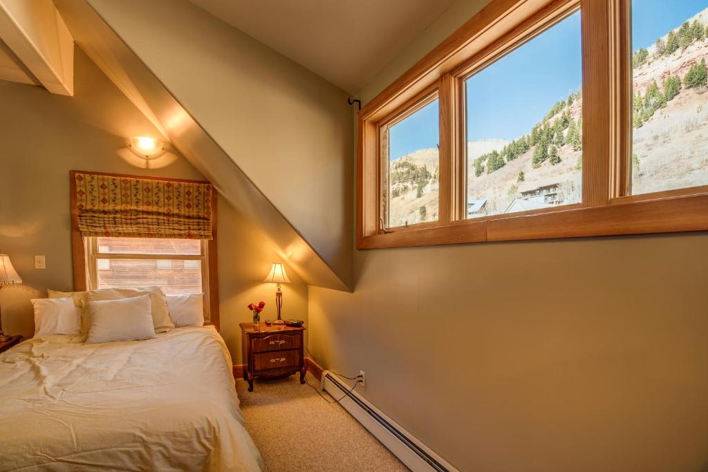 a bedroom with a bed and a window at Sunnyside East End in Telluride