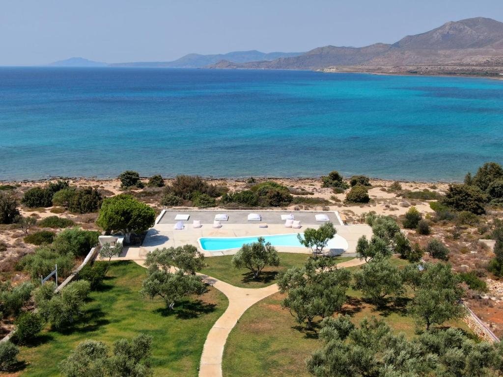 an aerial view of a resort with a pool and the ocean at Eight Dimensions Capari Suites Elafonisos in Elafonisos