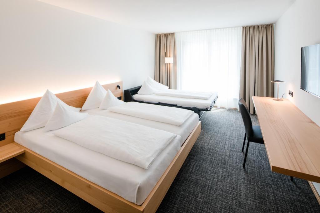 Postel nebo postele na pokoji v ubytování Hotel Krone