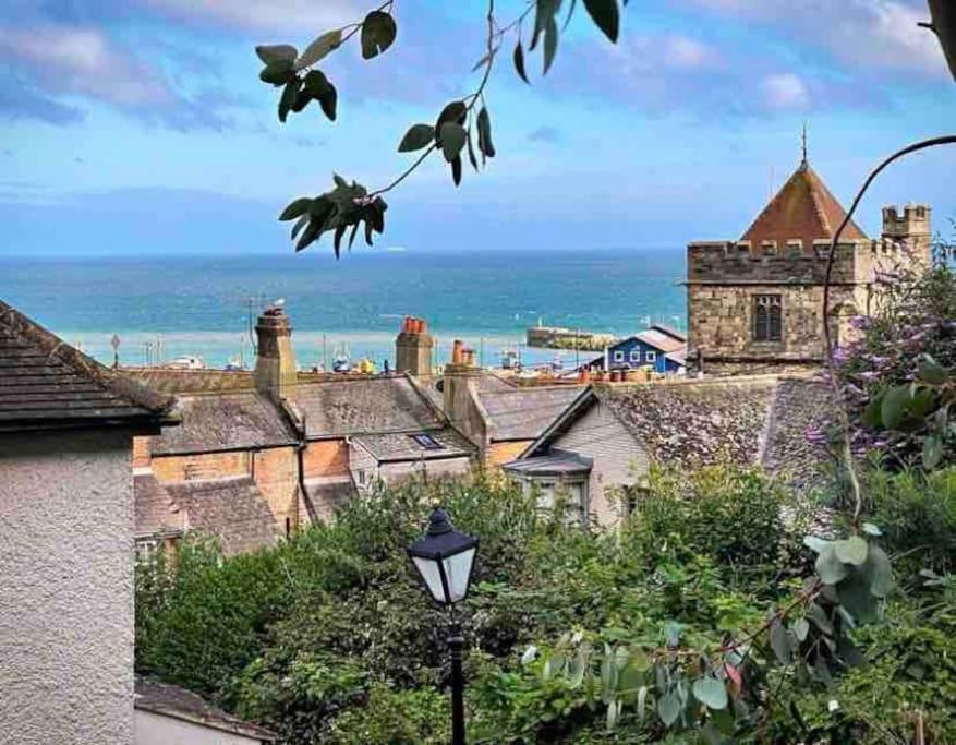 a view of a town with a castle and the ocean at Gloucester House in Hastings