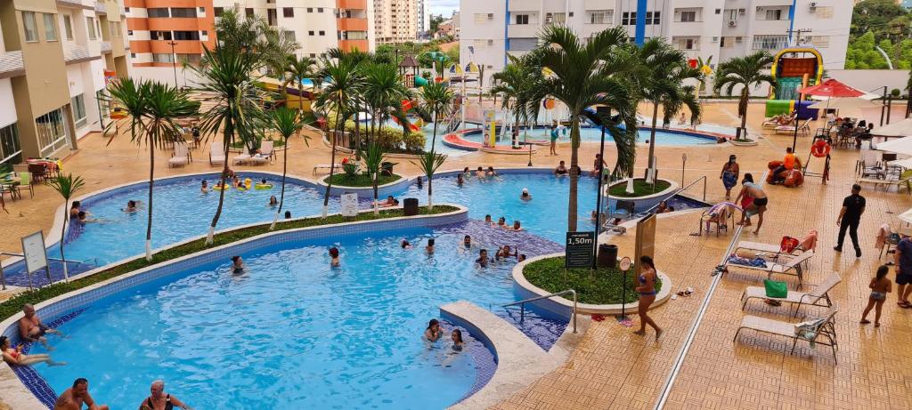 a group of people in a pool at a resort at Prive Riviera - Apartamentos JN in Caldas Novas