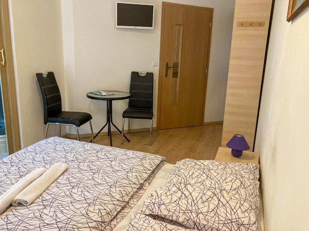 A bed or beds in a room at Vila Lesana