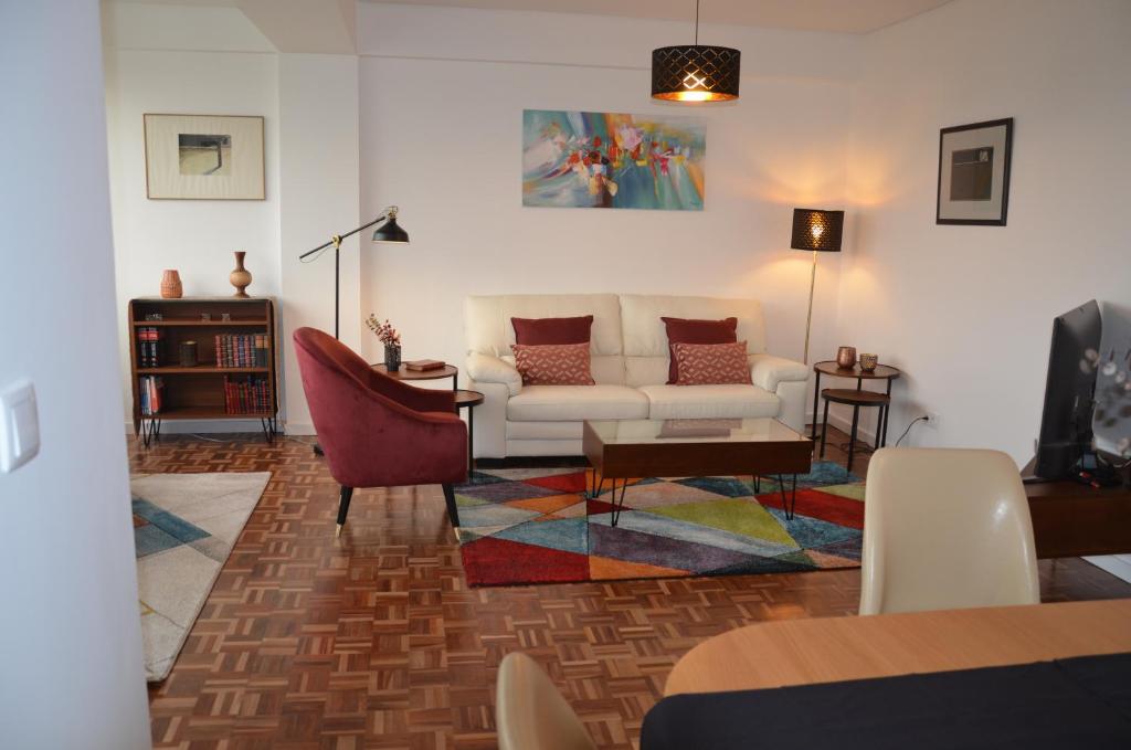 a living room with a couch and a table at Tagus Life Areeiro in Lisbon