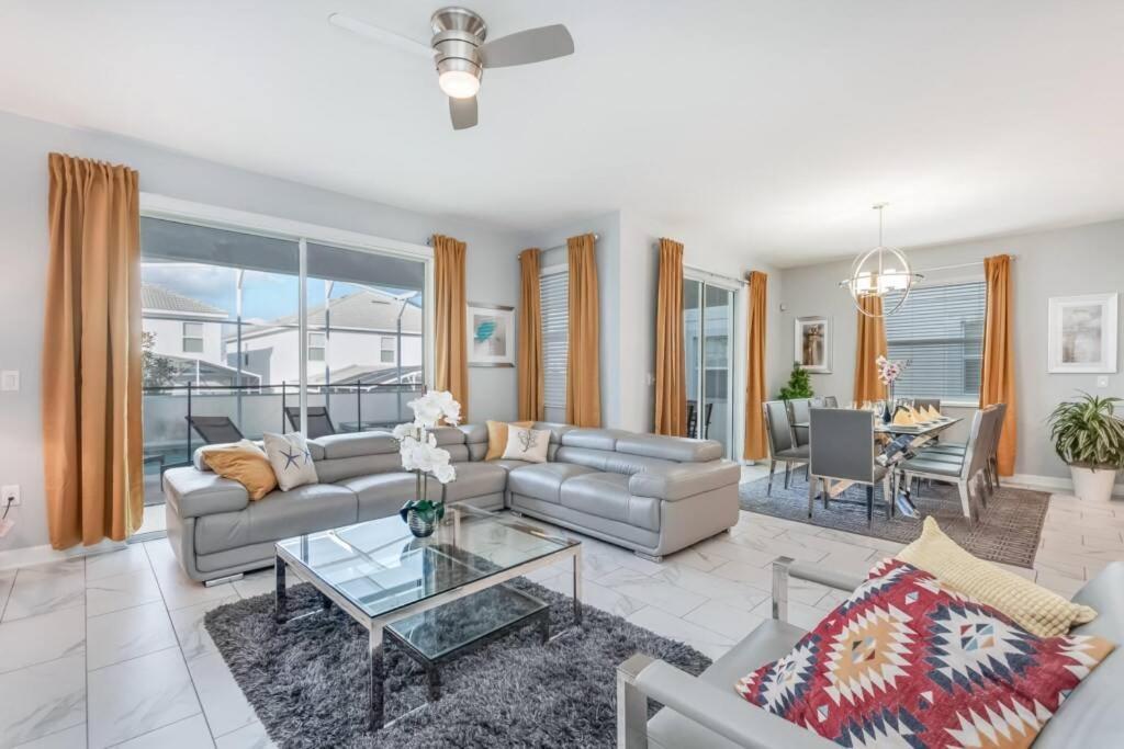 a living room with a couch and a table at Luxury Home inside Champions Gate - No Extra Fees in Davenport