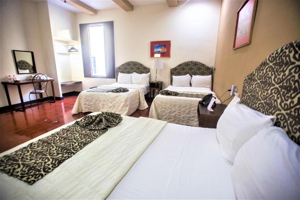 Postel nebo postele na pokoji v ubytování Hotel Merida