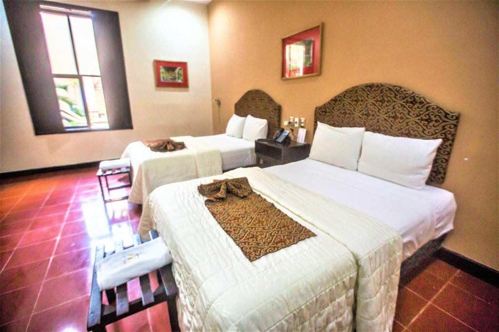 Postel nebo postele na pokoji v ubytování Hotel Merida