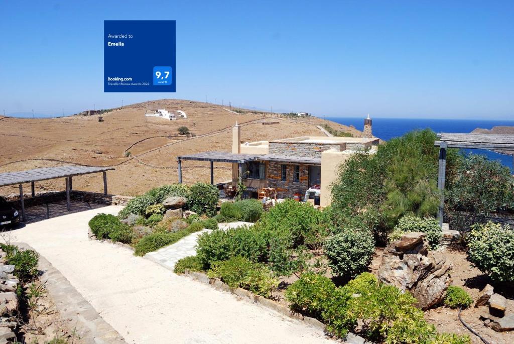 a house on top of a hill next to the ocean at Emelia in Otzias