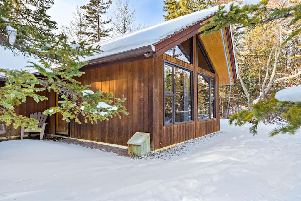 a cabin in the woods in the snow at Canmore Cabin by Canadian Rockies Vacation Rentals in Canmore